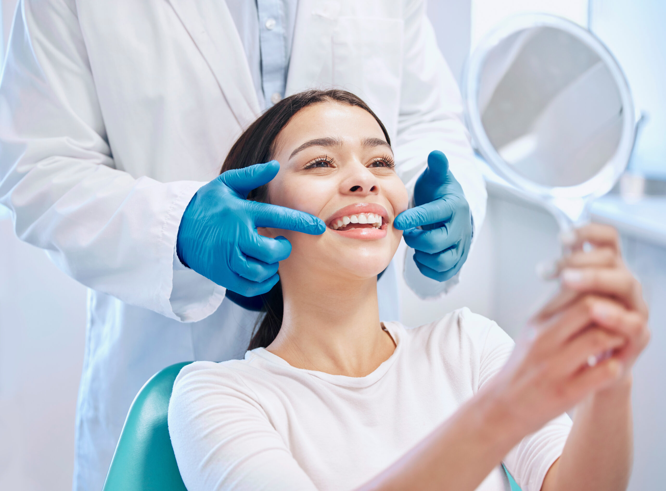 Dental consultation, mirror and woman with smile after teeth whitening, service or mouth care. Healthcare, dentistry and happy female patient with orthodontist for oral hygiene, wellness and cleaning Dental consultation, mirror and woman with smile after teeth whitening, service or mouth care. Healthcare, dentistry and happy female patient with orthodontist for oral hygiene, wellness and cleaning.