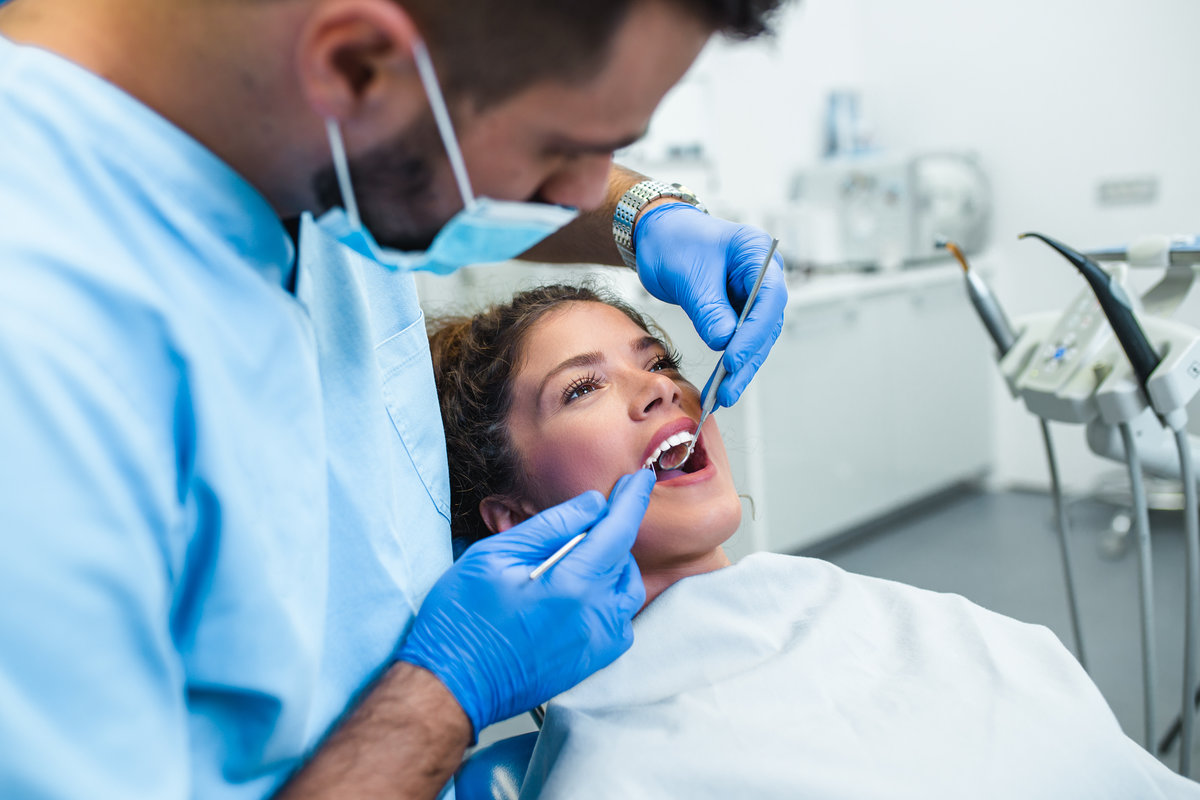 Dr. Brittany Wood performing dental exam at Shoreline Dentistry Virginia Beach