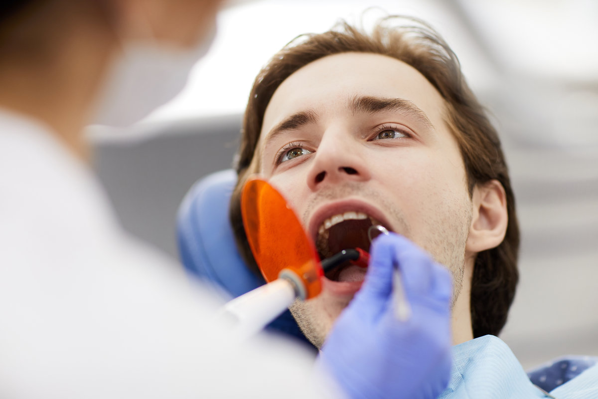 Laser Teeth Whitening Dr. Brittany Wood performing dental exam at Shoreline Dentistry Virginia Beach